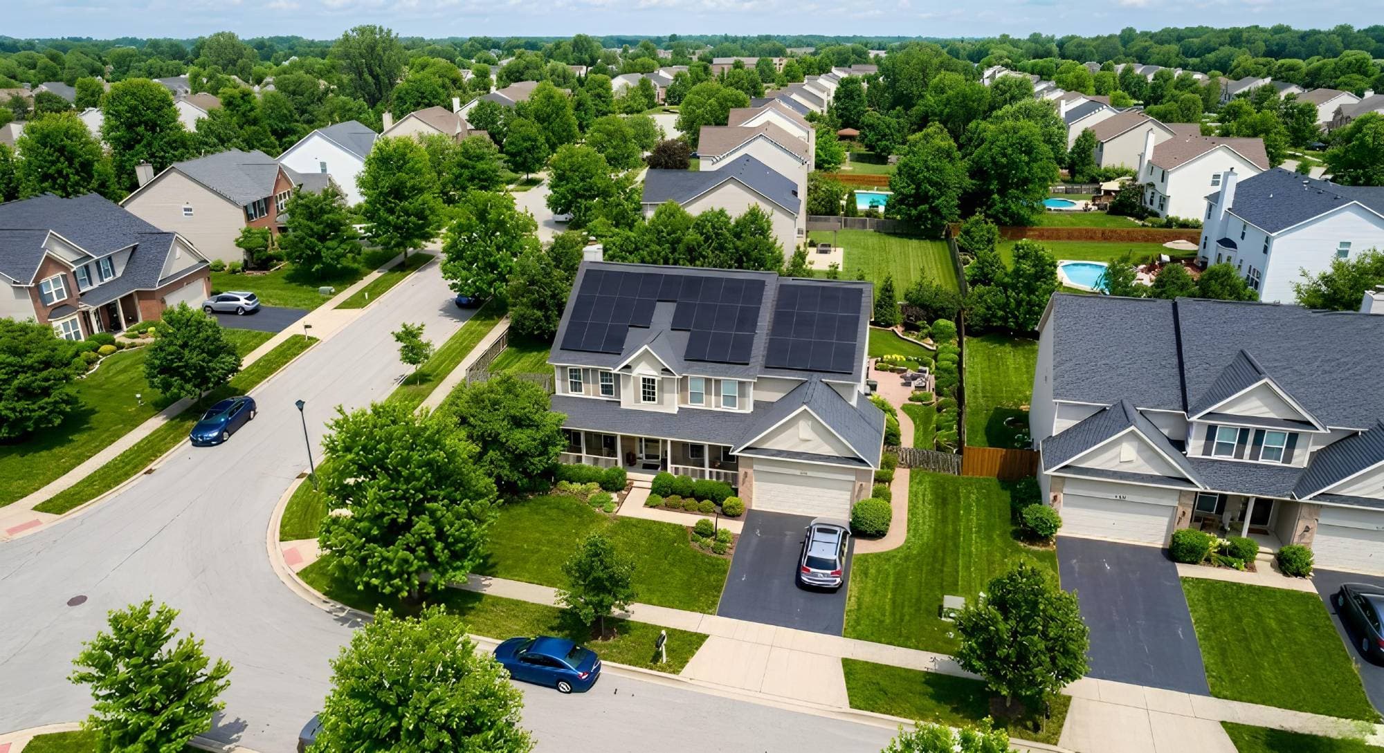 Aerial view of an Illinois neighborhood with solar panels on a home's roof